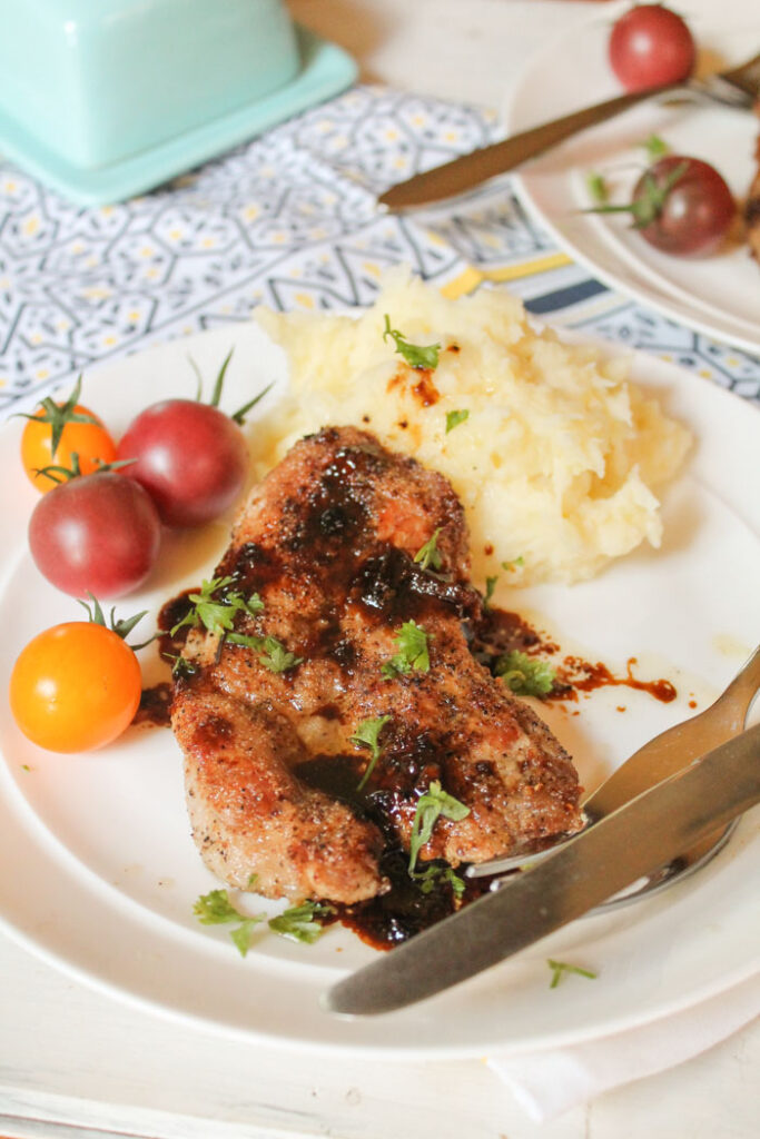 crispy slice of pork tenderloin topped with a reduced sauce and fresh parsley.