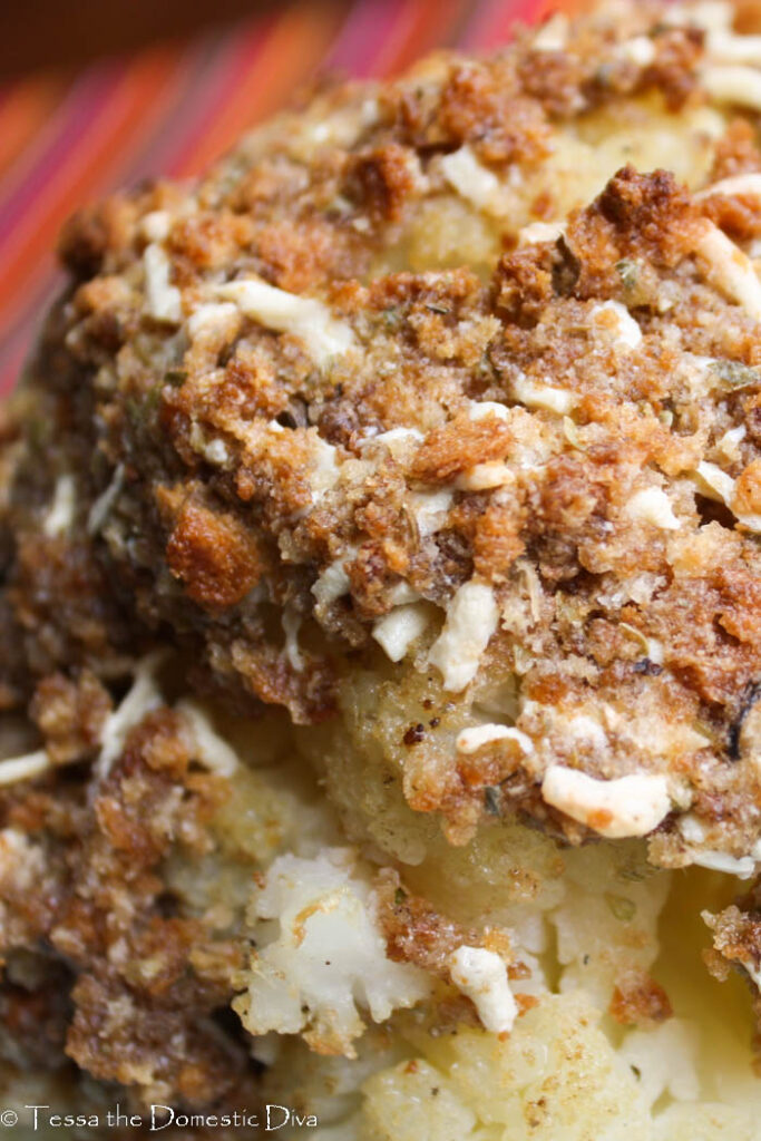 close up of a breaded roasted whole cauliflower head.