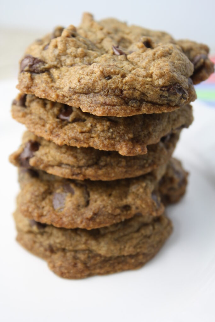a stack of gluten free vegan chocolate chip cookies on a white surface