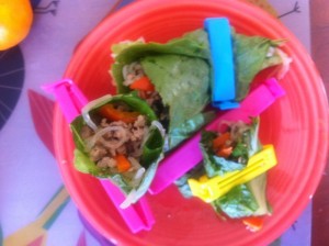 overhead view of bag clipped Asian lettuce wraps on red plate