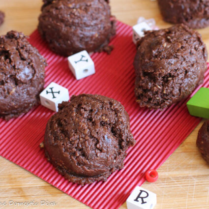 over head close up chocolate cookie ball with oat pieces and square white letter beads about