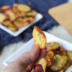 handheld homemade potato chip with everything seasoning