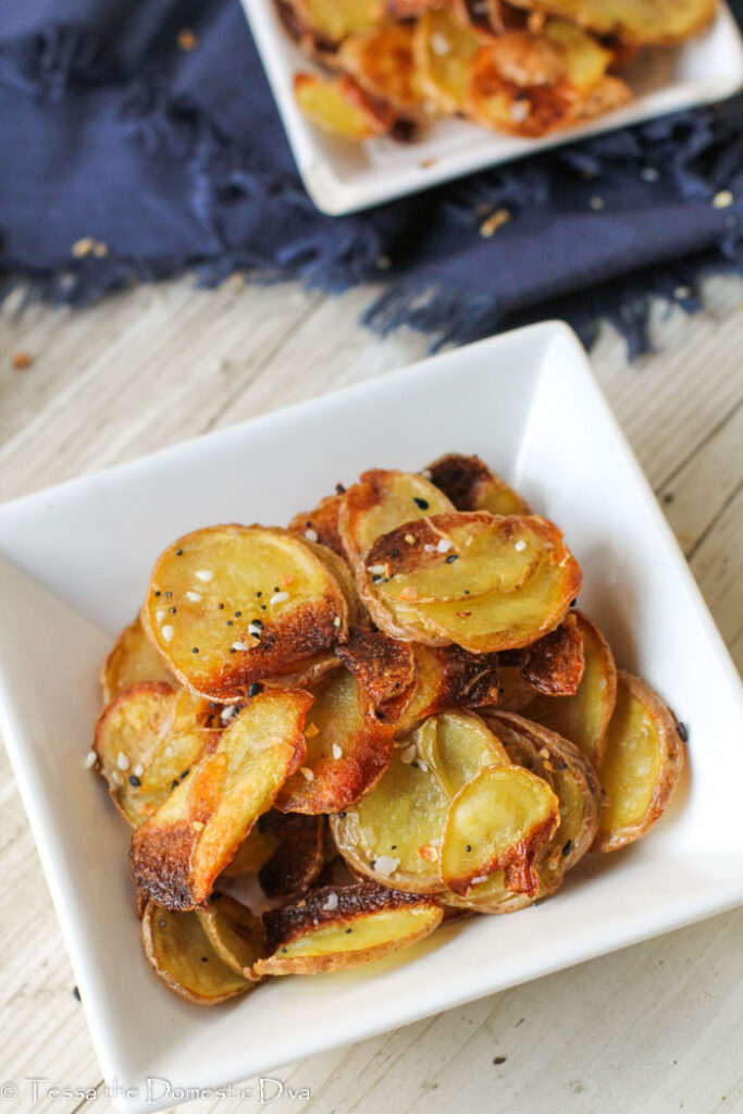 overhead view of a white dish filled with roasted potato slices.