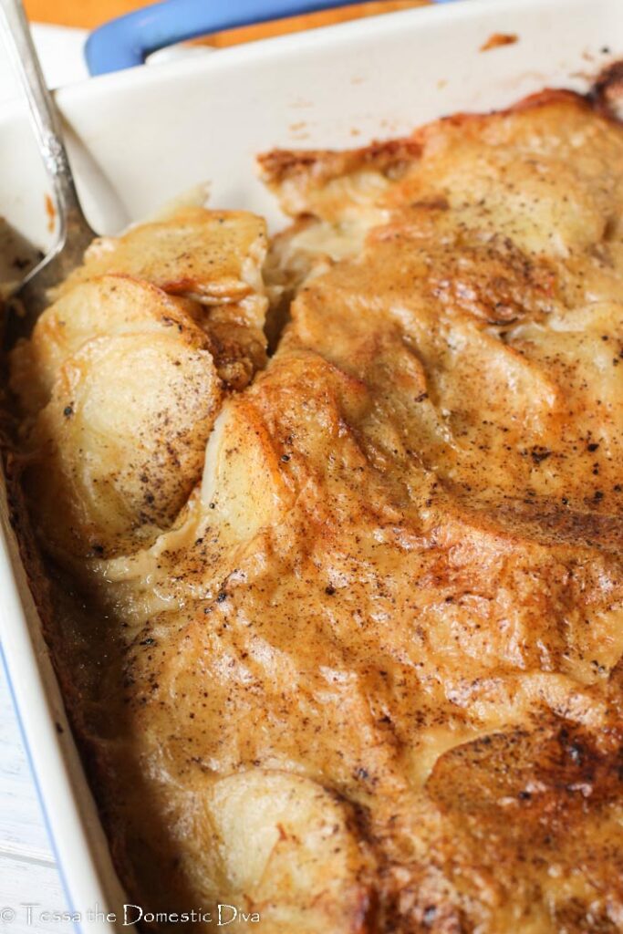 overhead view of a blue casserole dish with low fat scalloped potatoes