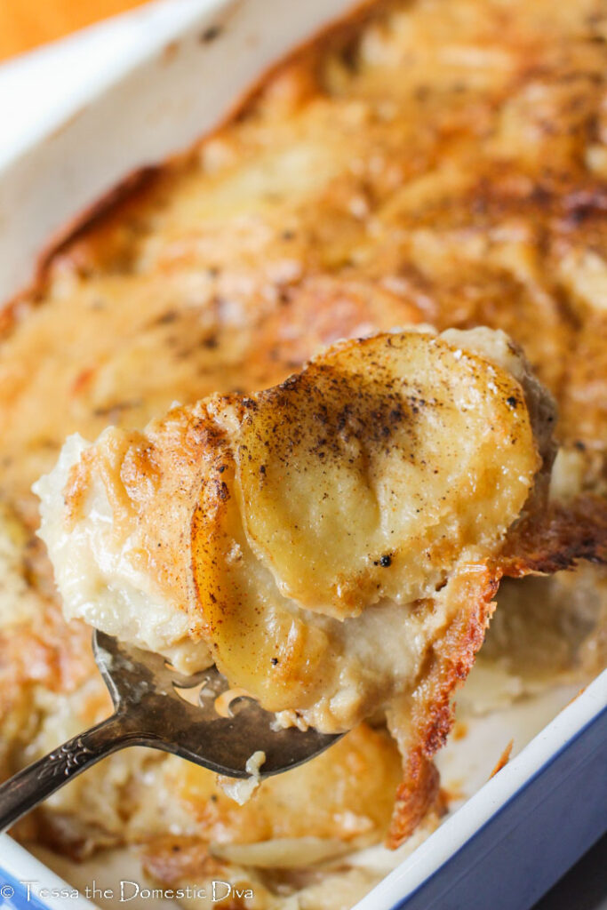 a scoop of creamy dairy free scalloped potatoes over the main dish