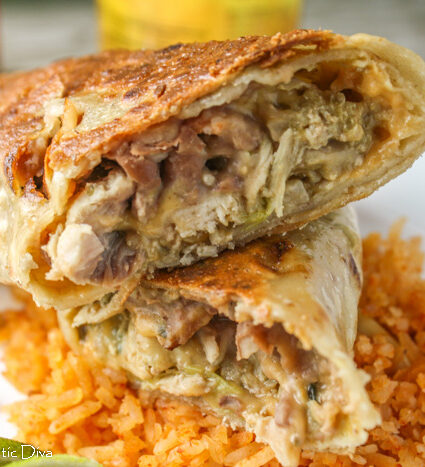 a sliced crispy chimichanga with refried beans, rcie, and pulled chicken in a green sauce