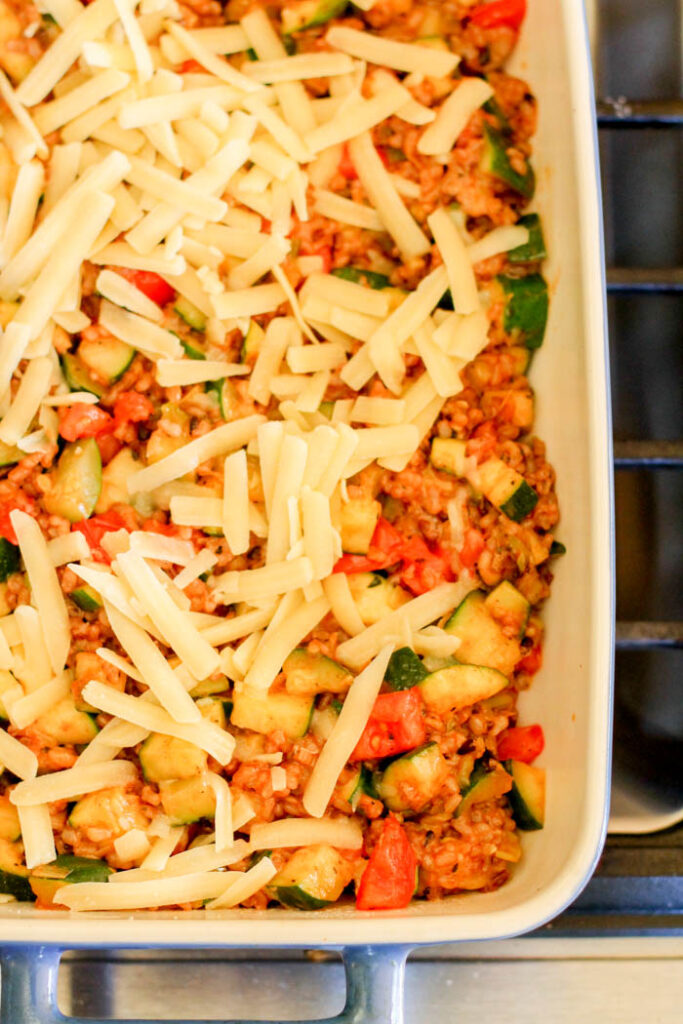 birds eye view of a cheese topped brown rice and zucchini casserole