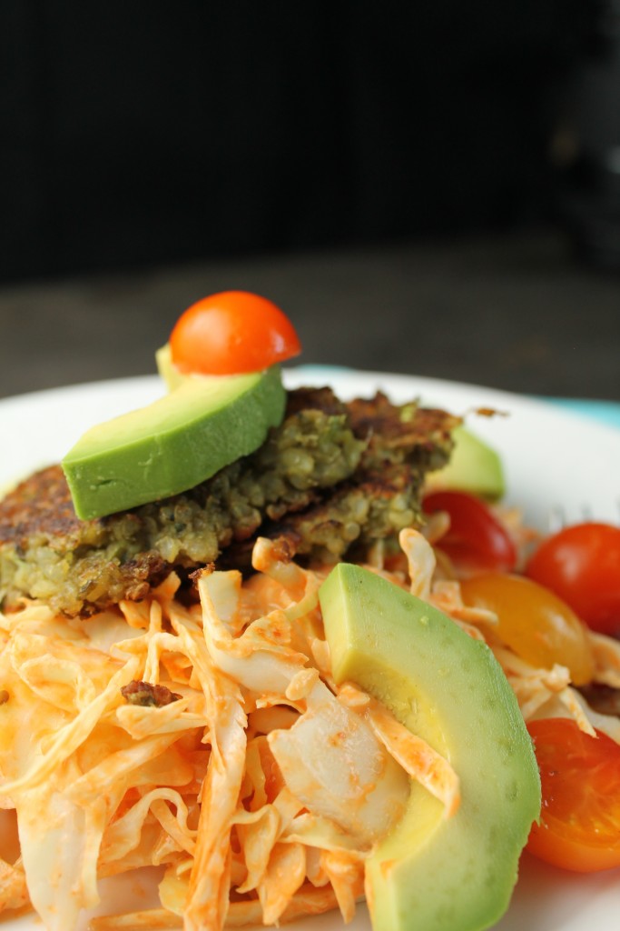 a spicy orange slaw topped with a vegetarian mung bean falafel with an avocado slice