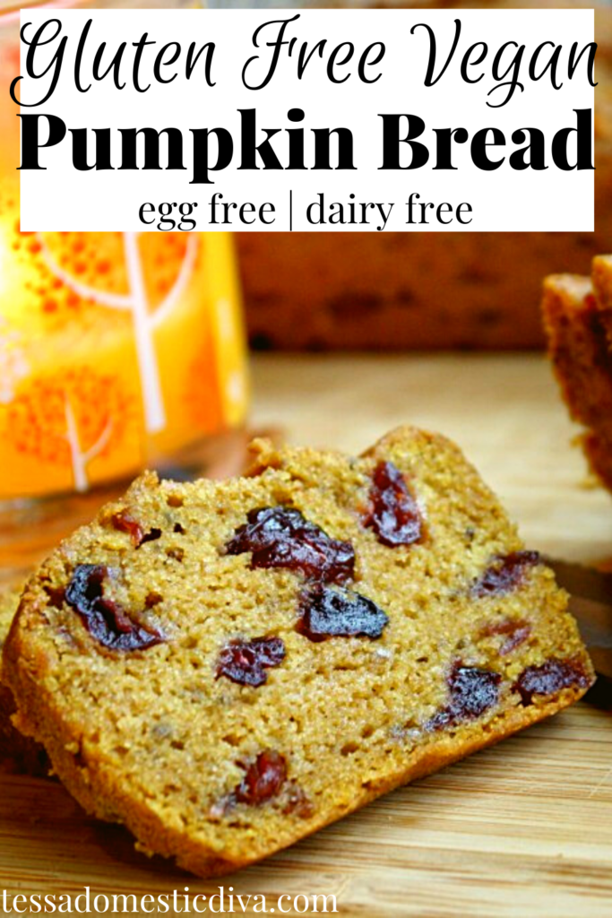 pinterest ready of an orange hued pumpkin loaf studded with dried cranberries, sliced on a bamboo cutting board