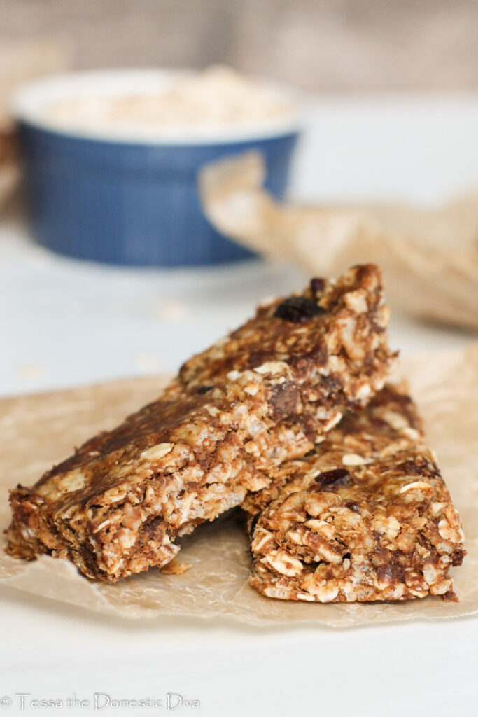 two homemade no bake granola bars on a piece of parchment.
