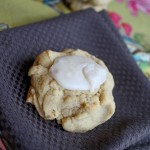 Gluten Free Vegan Pumpkin Cookies a single dense cookie on a brown linen with a dollop of creamy frosting
