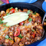 a pan filled with macaroni, hamburger in a tomato chili sauce