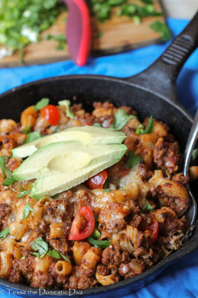 overhead view of a a noodle, tomato sauce, and ground beef casserole topped with cheese.