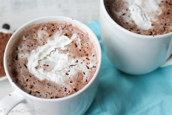 birds eye view of two white mugs with hot chocolate and melting cream