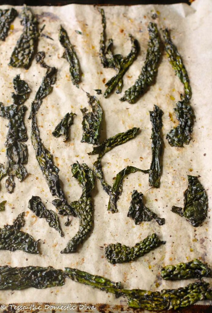 birds eye view of baked kale chips on unbleached parchment paper