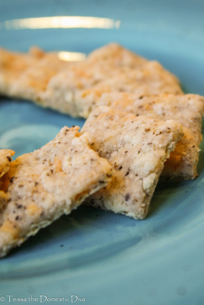 homemade dairy free cheez it crackers arranged on a turquoise plate