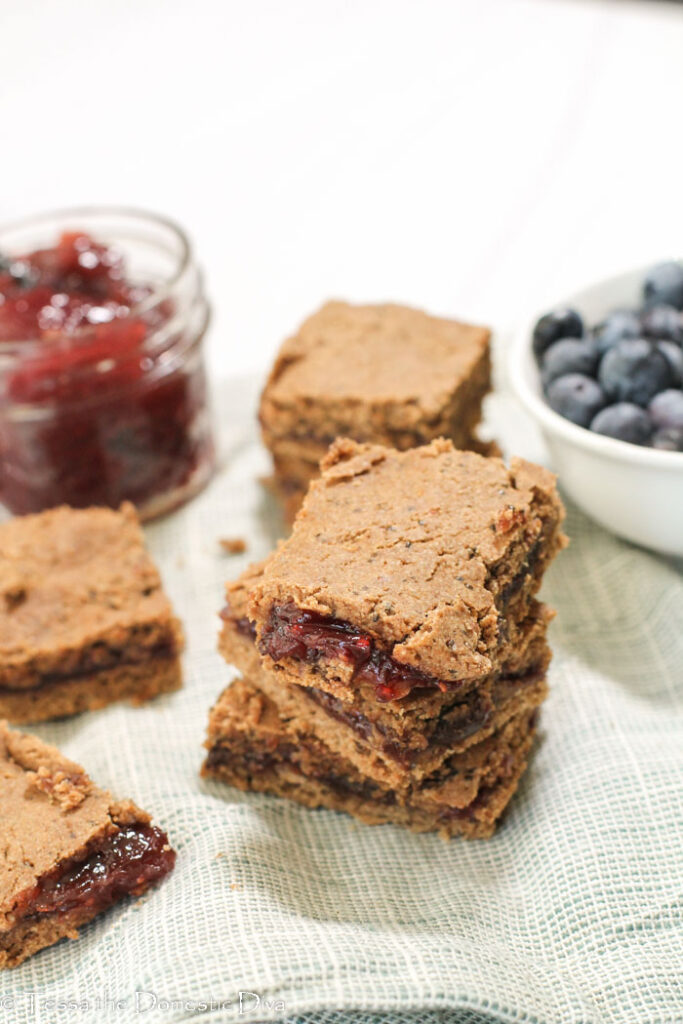 stack of three wholegrain fruit filled cereal bars with berry preserves