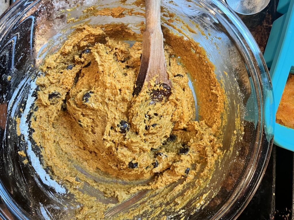 overhead view of pumpkin chocolate chip muffin batter in a glass bowl
