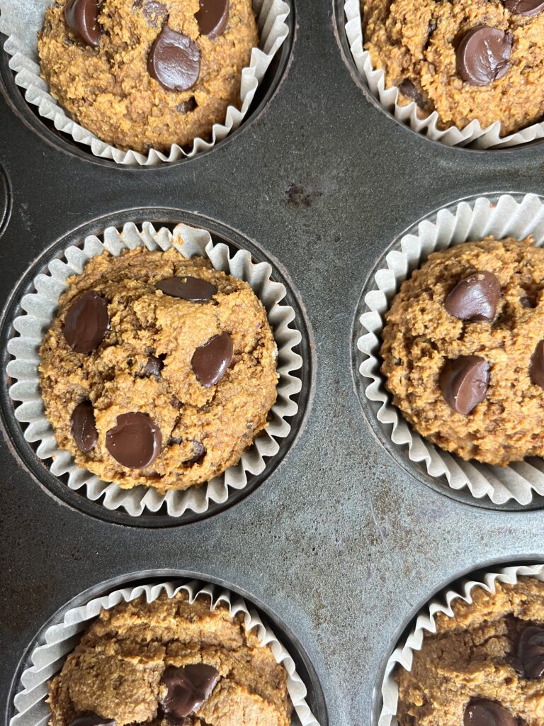 birds eye view of pumpkin chocolate chip muffins in a muffin tin