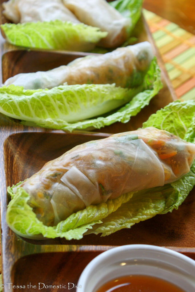 three tapioca wrapped fresh salad rolls on a lettuce leaf.