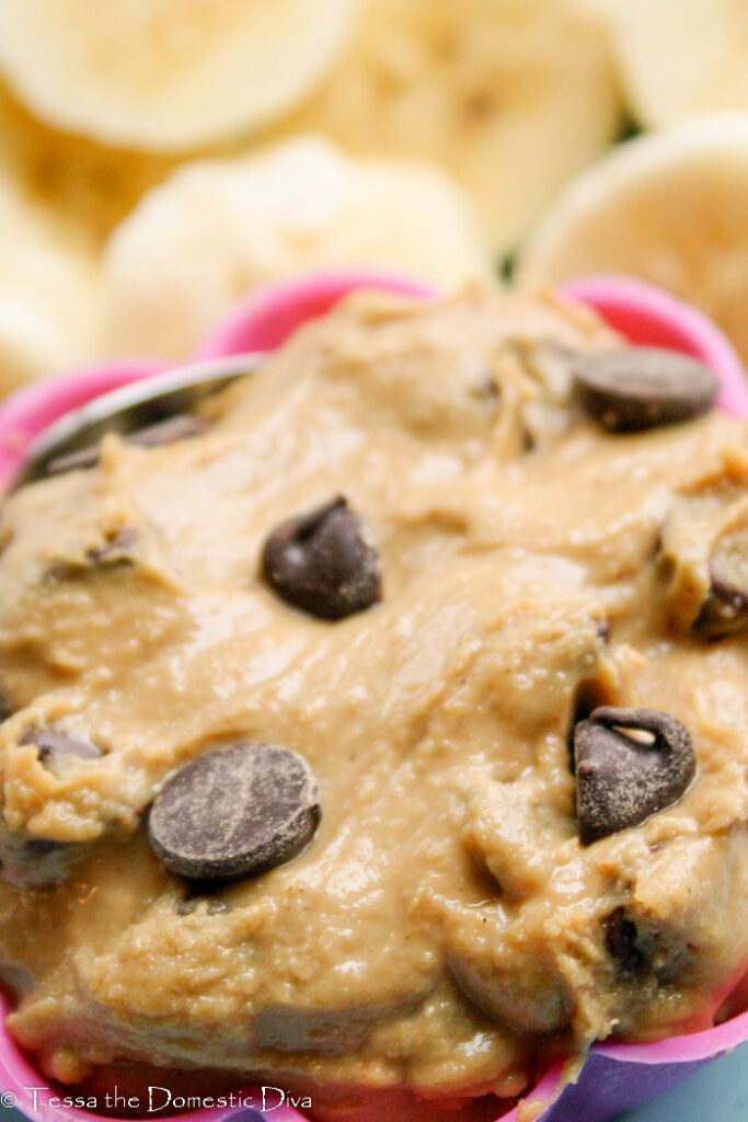 creamy peanut butter dip with chocolate chips and fresh banana slices