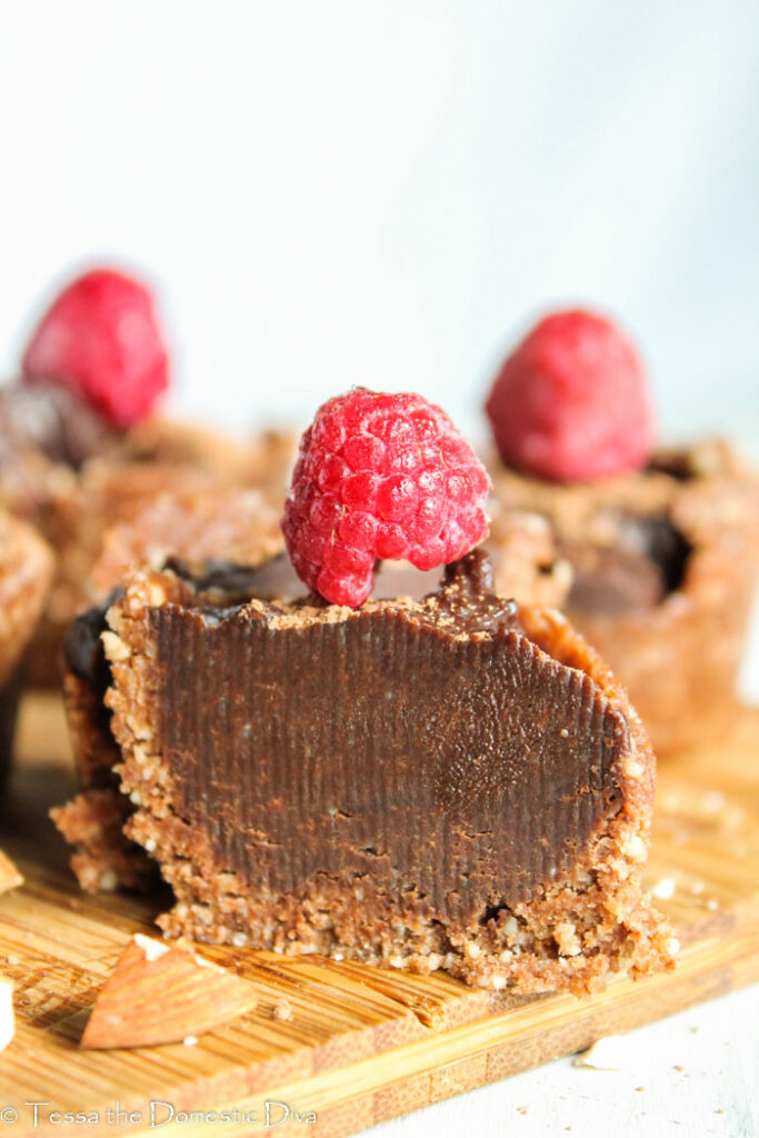 creamy chocolate cheesecake filling with a nut crust topped with a fresh raspberry and cut in half