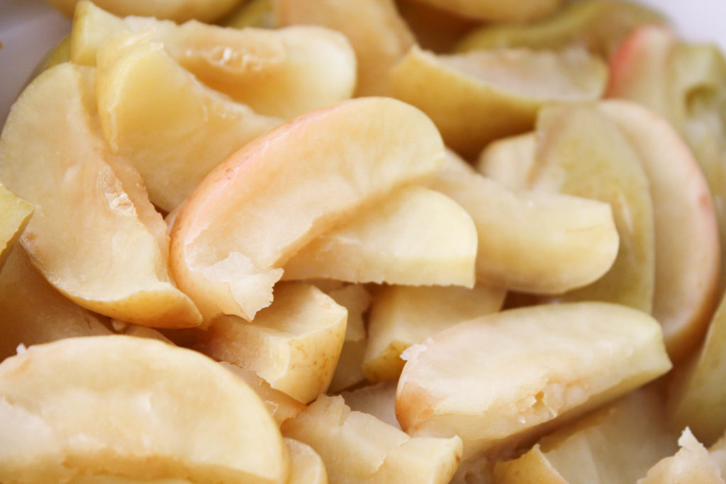Creamy No-Peel Applesauce - Blender close up of cooked and wilted apple slices with the peels on