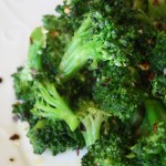 a plate full of bright green and crisp tender sauteed broccoli with garlic and red pepper