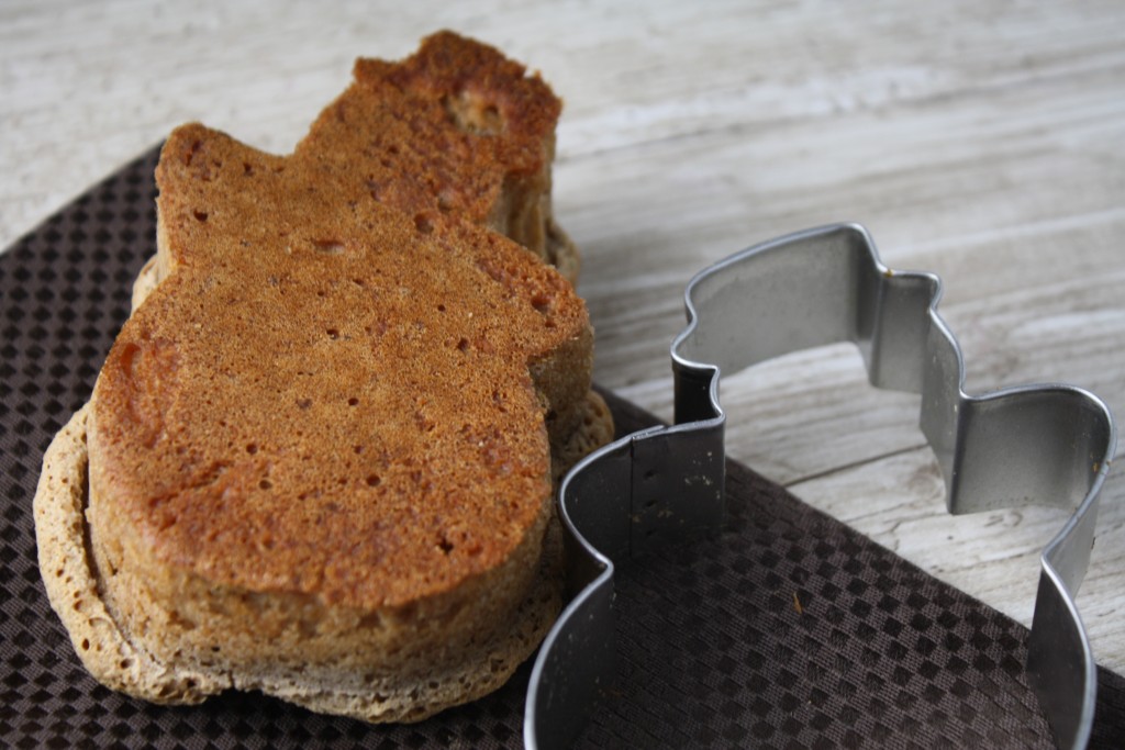 a snowman shaped english muffin next to its cookie cutter form