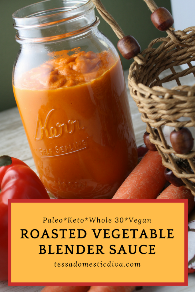 optimized for pinterest quart size glass mason jar filled with an orange roasted vegetable sauce and fresh carrots and red peppers