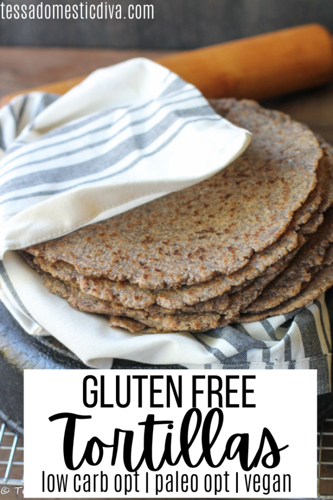 pinterest ready stack of tortillas in an off white cloth atop a cast iron skillet with a wooden rolling pin in background