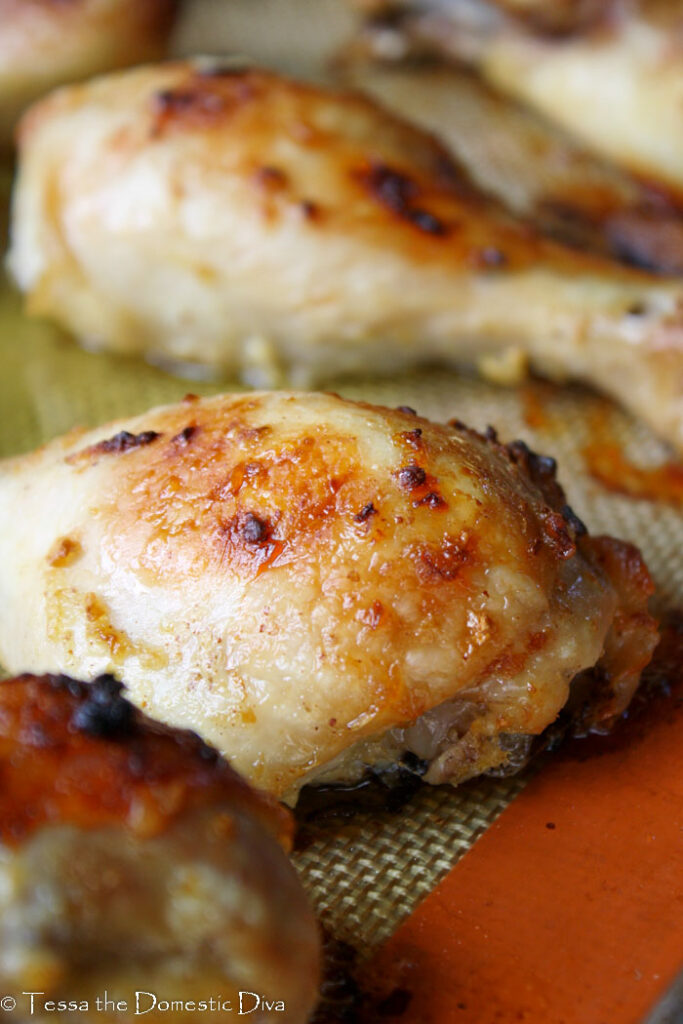 roasted and crispy brown lemon garlic marinated chicken drumsticks on a non-stick baking mat