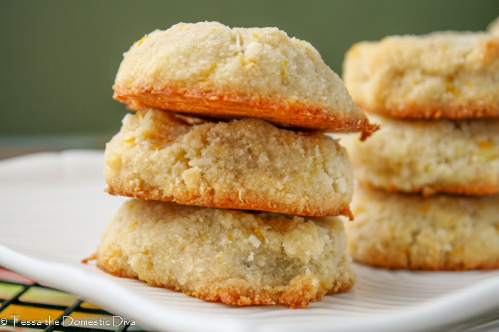 3 stacked vegan orange almond cookies on white plate