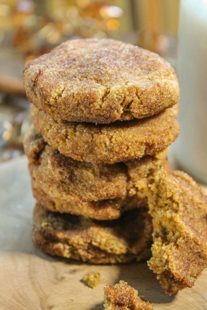 a close up of five stacked pumpkin cookies with a coating of cinnamon and sugar