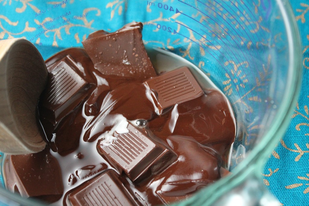 partially melted chcoclate squares in a glass pyrex measuring cup