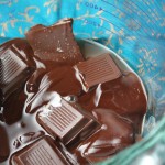 partially melted chcoclate squares in a glass pyrex measuring cup