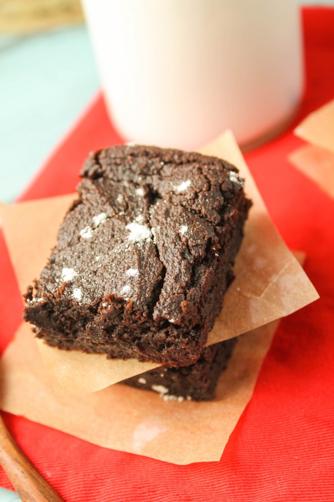 birds eye view of a stack of three brownies with a sprinkle of powdered sugar.