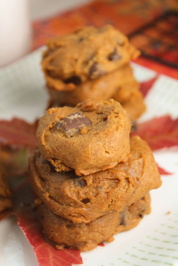vertical image of stacked orange hues and chocolate studded gluten free pumpkin cookies