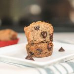 paleo banana bread muffins on a white plate with ooey gooey chocolate chips on a white square plate with a dark background