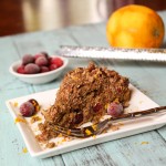 a slice of struesel topped coffee cake with cranberries and orange