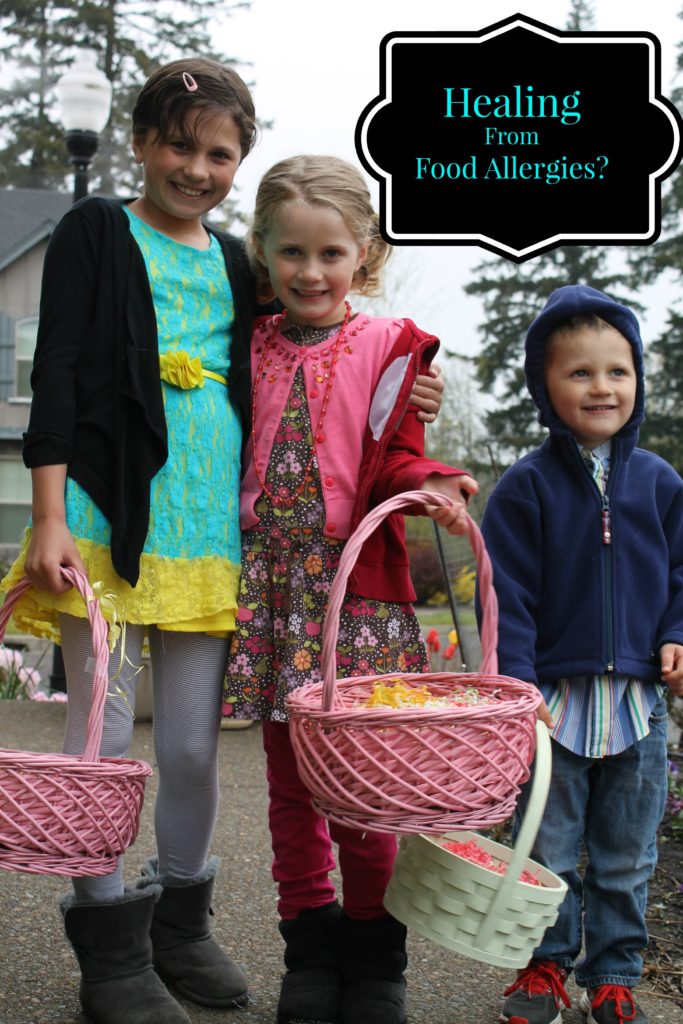 optimized for pinterest 3 kids holding Easter baskets outside on the sidewalk