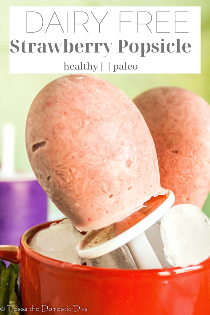 pinterest ready homemade strawberry popsicles standing in a red mug.