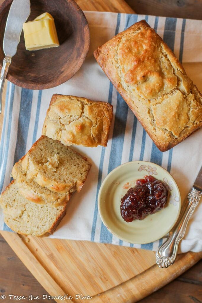 birds eye view of two sliced mini loaves of low carb bread with butter and jelly