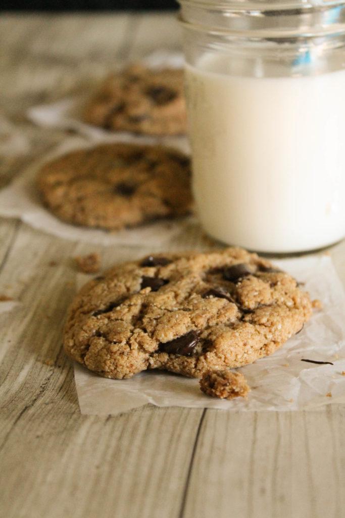 cashew chocolate chip cookies with glass of milk in a mason jar in background