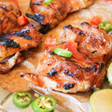 grilled bneless chicken thighs topped with red peppers, jalapeños, and fresh lime slices