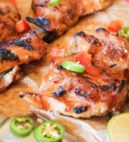 grilled bneless chicken thighs topped with red peppers, jalapeños, and fresh lime slices