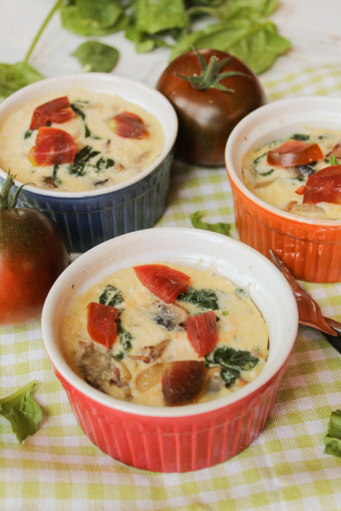 3 ramekins of mini instant pot quiches on a lime and white gingham cloth and a tomato and spinach filling