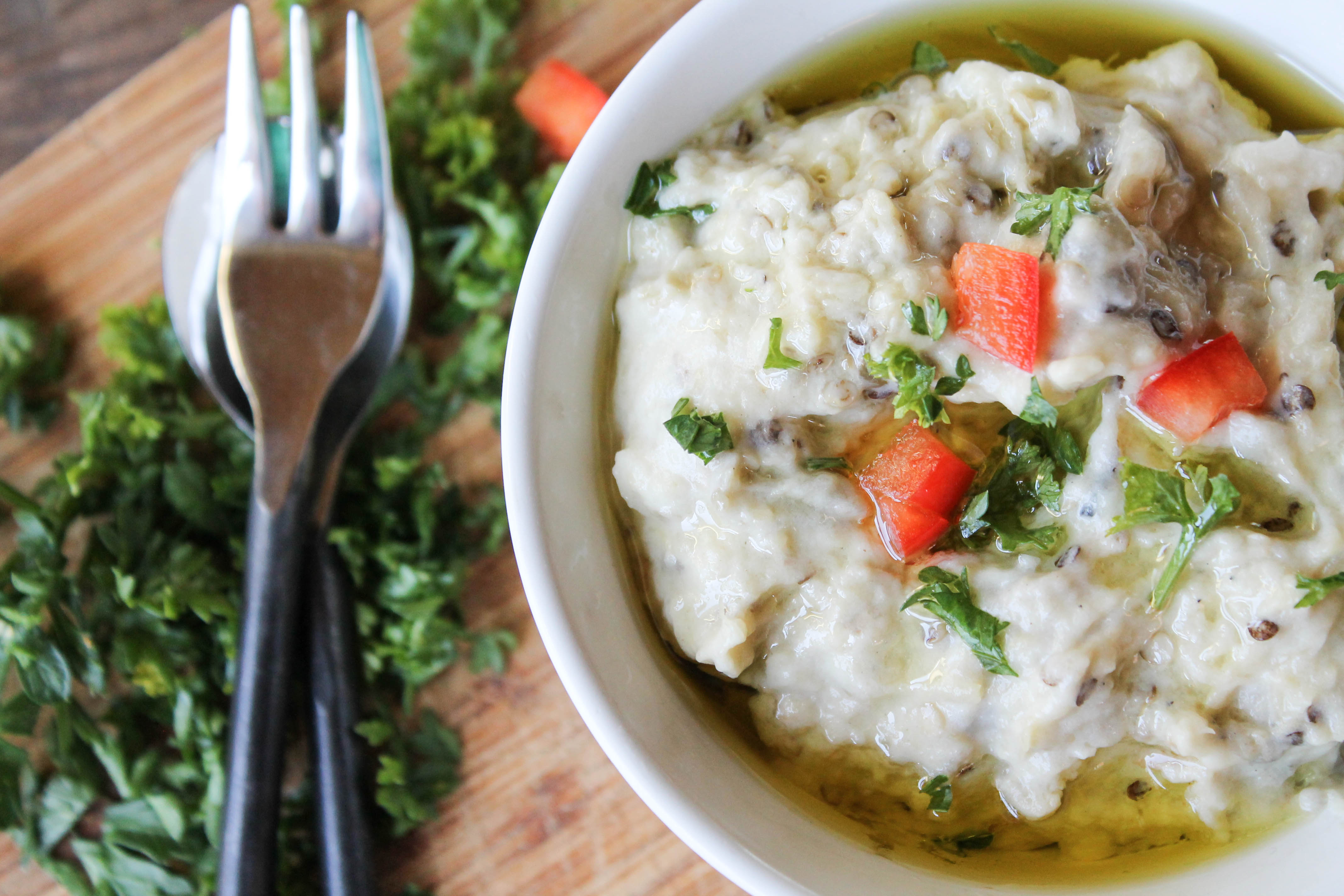 an overhead view of Israeli eggplant dip in a white bowl.