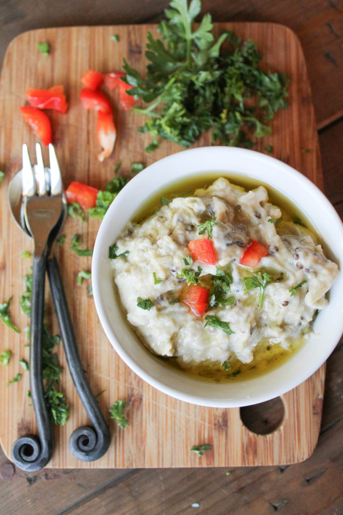 birds eye view of grilled eggplant dip in a white bowl.