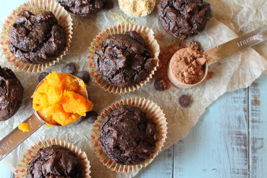 a collage of chococlate butternut muffins from above with a scoop of squash puree, cocoa powder, and almond flour placed around